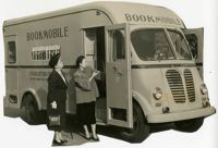 Emily Sanders and Mary McBee examime bookmobile