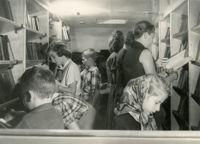 Readers browsing books in bookmobile