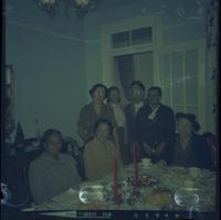 Color negative of Parker and others at a gathering