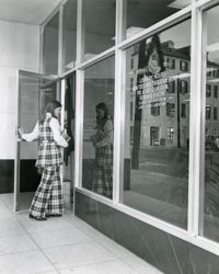 Young woman entering front door of Main Library