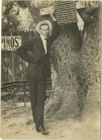 Man Leaning Against Tree