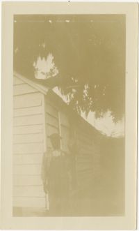 Man with Shovel in Front of Slave Cabin