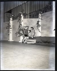 A Woman and Child Stepping Off a Stage