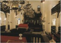 Curaçao, Netherlands Antilles. Interior of Mikve Israel-Emmanuel Synagogue, dedicated in 1732, oldest in continuous use in Western Hemisphere. View shows mahogany Hekhal containing 18 scrolls and beautiful old brass chandeliers over sand covered floor.
