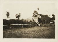 Mario Pansa (assumed) guiding a horse through a jump