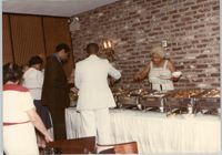 Photograph of People Serving Food at a Buffet