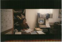 Photograph of a Woman Seated at a Desk