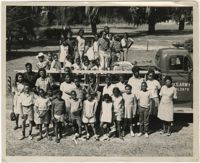 Photograph of Children Standing by a U.S. Army Vehicle