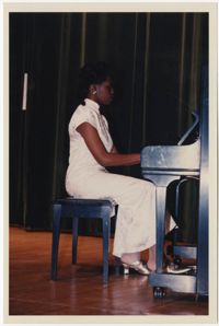 Photograph of a Young Woman Playing Piano