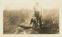 J.R. Scott in Asparagus Field with Dog