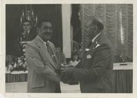 Photograph of J. Arthur Brown Shaking Hands with an Unidentified Man