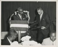 Photograph of Man Presenting Award to Another Man