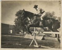 Photograph of a Man in Uniform Riding a Horse