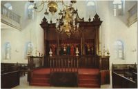 Interior of Mikve Israel-Emanuel Synagogue, dedicated in 1732, oldest in continuous use in Western Hemisphere. View is towards Hechal containing 18 scrolls and is taken from Tebah (reading platform) in center of sandcovered floor.