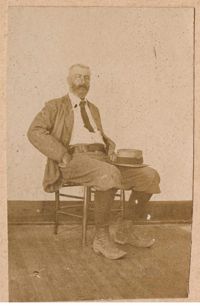 Conrad Donner sitting in chair, looking slightly towards left