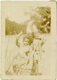 Herbert U. Seabrook, Jr. and Charles DeCosta sitting on a ladder