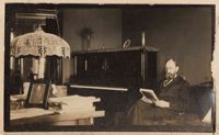 Christopher Donner reading beside piano