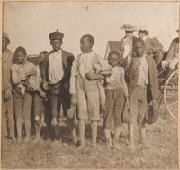 Group of children in front of wagon