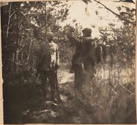 Two men hunting in the woods