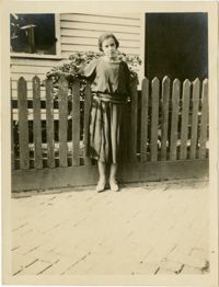 Woman standing in front of fence