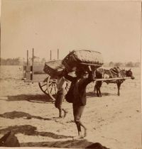 Two men with bushel baskets and wagon
