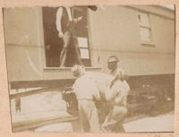 Loading packing crates onto railroad car