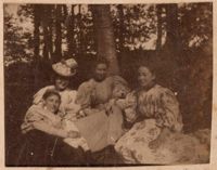 Group of four women and one dog in woodland setting